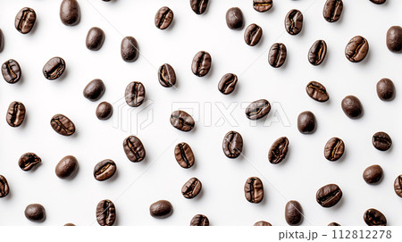 Coffee beans artfully arranged on the white background create a mesmerizing pattern Coffee beans artfully arranged on the white background create a mesmerizing pattern 112812278