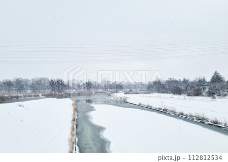 Snow Covered Field With River Running Through Snow Covered Field With River Running Through 112812534