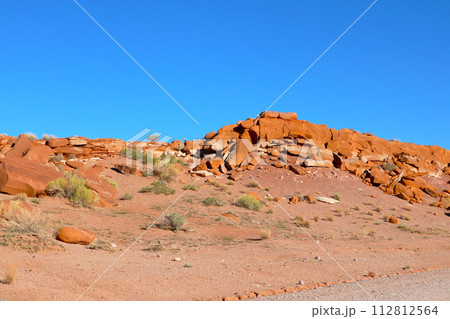 Massive Rock Formation in Desert Landscape 112812564