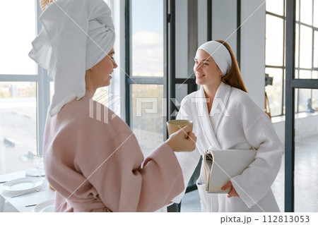 Portrait of two positive girl friends talking together in morning Portrait of two positive girl friends talking together in morning 112813053