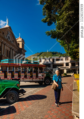 Senior woman tourist at the central square of the beautiful small town of Pacora in the department of Caldas in Colombia Senior woman tourist at the central square of the beautiful small town of Pacora in the department of Caldas in Colombia 112813939