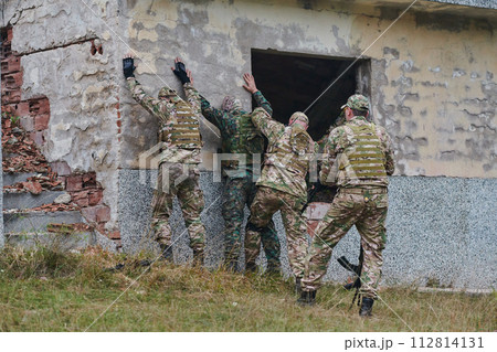 In a high stakes mission, a specialized military unit executes a tactical operation to secure a dangerous house where terrorists are believed to be hiding, showcasing precision and coordinated 112814131
