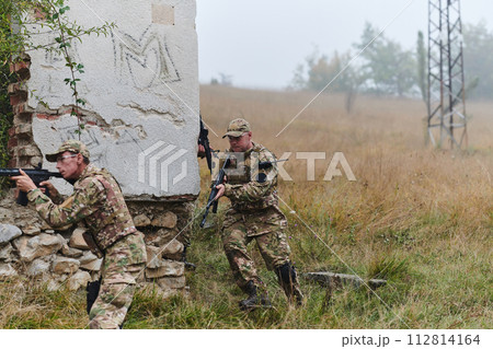 In a high stakes mission, a specialized military unit executes a tactical operation to secure a dangerous house where terrorists are believed to be hiding, showcasing precision and coordinated 112814164