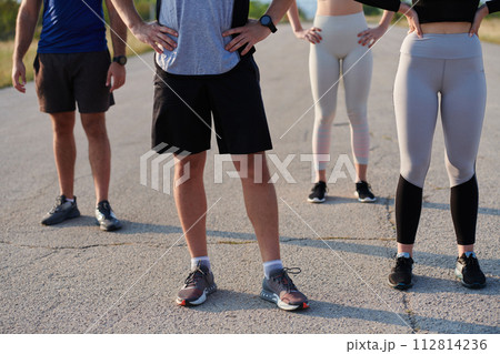 Diverse Athletic Warm-Up: Group Prepares for Intense Running Challenge. 112814236