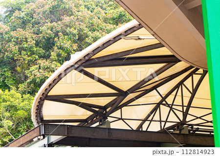 Structure Roof Dome construction, canvas and metal sheet for event. White, brown canvas roof semi circle. Mountains and forests in the background. Excellent protection from sunlight and rainstorms.	 112814923