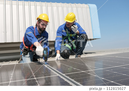 Engineers install solae cell on the roof of factory Engineers install solae cell on the roof of factory 112815027