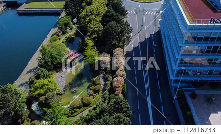 Drone view on Japanese garden in Le Havre with rhododendron blossoms, pond Drone view on Japanese garden in Le Havre with rhododendron blossoms, pond 112816733