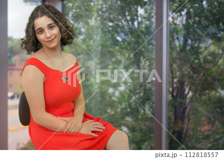 young woman student in office defocused window background businesswoman workplace curly hair brunette young woman student in office defocused window background businesswoman workplace curly hair brunette 112818557