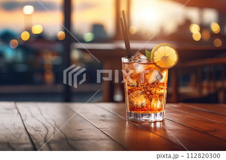 Cocktail on a wooden tabletop. Beautiful background with bokeh. 112820300