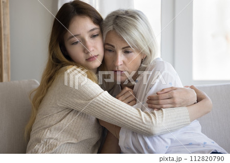 Loving empathetic pre-teen daughter cuddling her mature frustrated mother 112820790