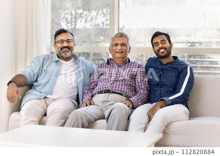 Adult Indian grandson and son spending leisure time with grandpa Adult Indian grandson and son spending leisure time with grandpa 112820884