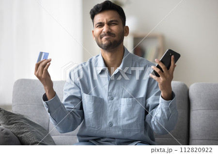 Man having problems with e-payment, scam or failed transaction Man having problems with e-payment, scam or failed transaction 112820922