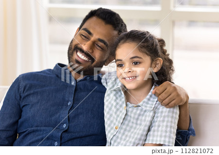 Happy Indian dad and pretty preschool daughter kid looking away Happy Indian dad and pretty preschool daughter kid looking away 112821072