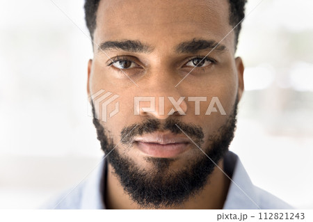 Close up shot of serious African man looking at camera 112821243