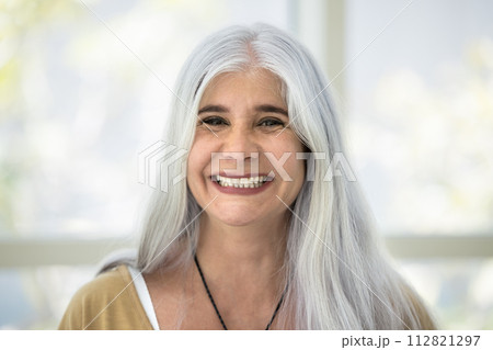 Happy naturally grey haired senior Latin woman head shot portrait Happy naturally grey haired senior Latin woman head shot portrait 112821297