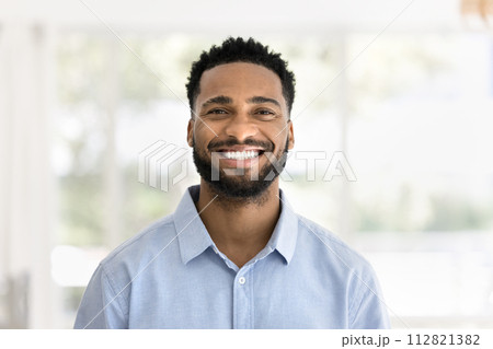 Cheerful handsome young African man head shot front portrait 112821382