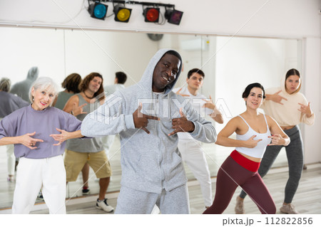 African American man practicing hip-hop movements during group class 112822856
