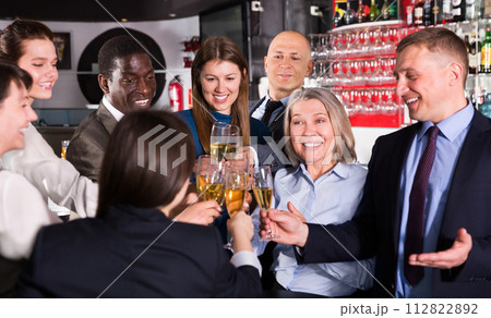 Colleagues clinking glasses of champagne on corporate party Colleagues clinking glasses of champagne on corporate party 112822892
