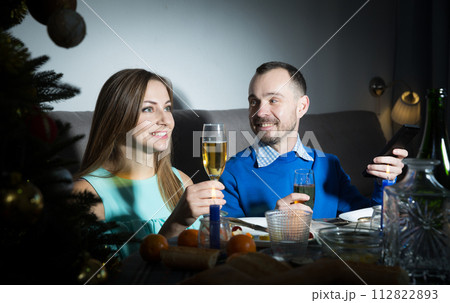 Cheerful couple celebrating Christmas Cheerful couple celebrating Christmas 112822893