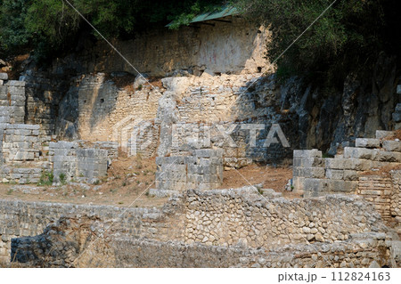Ruins of Great Basilica in Butrint National Park, Buthrotum, Albania. Triconch Palace at Butrint Life and death of an ancient Roman house Historical medieval Venetian Tower surrounded. High quality 112824163