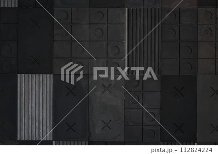 Textured gray, black geometric background made of concrete, paste with stripes, squares, circles, crosses, tic-tac-toe, copy space. Concept of abstract modern wall design with bulky convex elements 112824224
