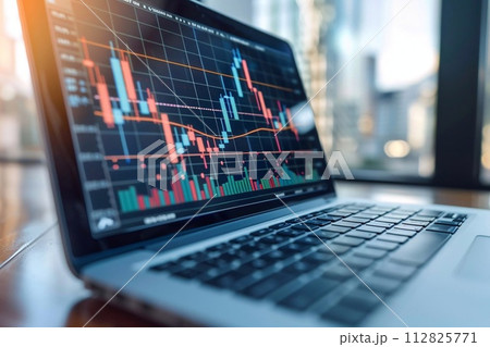 Laptop displaying stock charts and graphs. 112825771