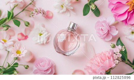 Perfume bottle in flowers, fragrance on blooming background, floral scent and cosmetic product 112825896