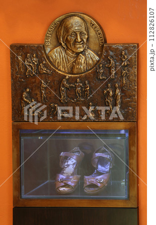Bass relief with scenes from the life of Saint Mother Teresa of Calcutta and her sandals exposed in Chapel of Saint Dismas in Zagreb, Croatia Bass relief with scenes from the life of Saint Mother Teresa of Calcutta and her sandals exposed in Chapel of Saint Dismas in Zagreb, Croatia 112826107