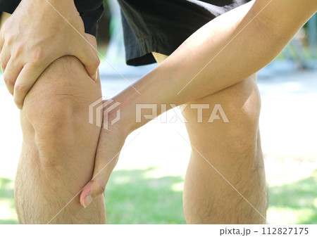 Knee pain .man standing caught his knee.  health concepts 112827175