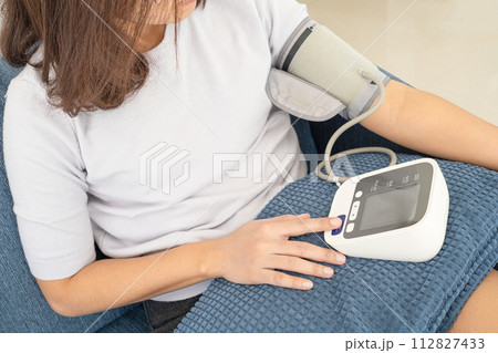 Man check blood pressure monitor and heart rate monitor with digital pressure gauge. Health care and Medical concept Man check blood pressure monitor and heart rate monitor with digital pressure gauge. Health care and Medical concept 112827433