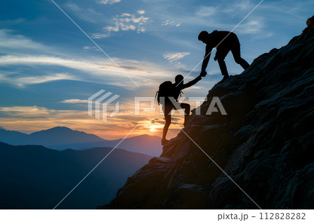Silhouette of couple hiking help each other silhouette in mountains with sunlight Silhouette of couple hiking help each other silhouette in mountains with sunlight 112828282