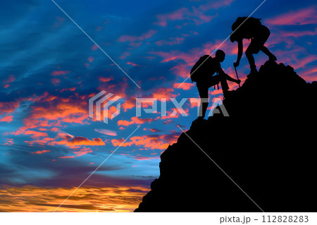 Silhouette of couple hiking help each other silhouette in mountains with sunlight Silhouette of couple hiking help each other silhouette in mountains with sunlight 112828283