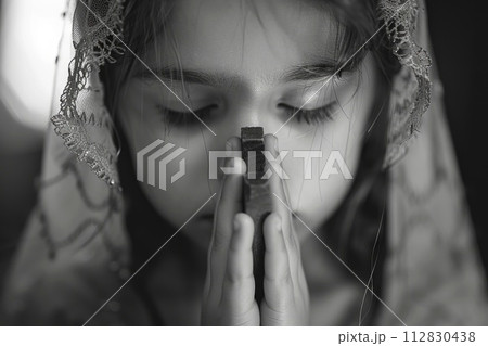 Sacred milestone: capturing the essence of first communion in a tender and symbolic portrayal, where young believers embrace the solemnity and spirituality of this significant rite 112830438