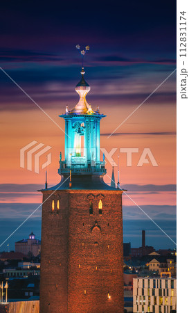 Stockholm, Sweden. Close View Of Famous Tower Of Stockholm City Hall. Popular Destination Scenic In Sunset Twilight Dusk Lights. Evening Lighting Stockholm, Sweden. Close View Of Famous Tower Of Stockholm City Hall. Popular Destination Scenic In Sunset Twilight Dusk Lights. Evening Lighting 112831174