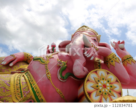Close up of pink Ganesha statue recline posture. 112834781