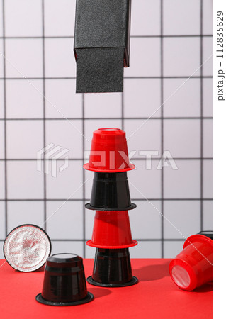 Coffee capsules on red table on light background 112835629