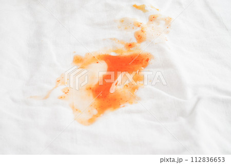 Dirty tomato sauce stain or ketchup on cloth to wash with washing powder, cleaning housework concept. 112836653
