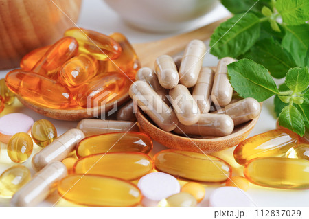 Alternative medicine herbal organic capsule with vitamin E omega 3 fish oil, mineral, drug with herbs leaf natural supplements for healthy good life. 112837029
