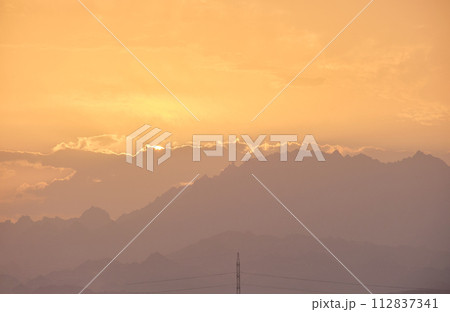 Sunset landscape with dark mountain peaks in egyptian desert Sunset landscape with dark mountain peaks in egyptian desert 112837341