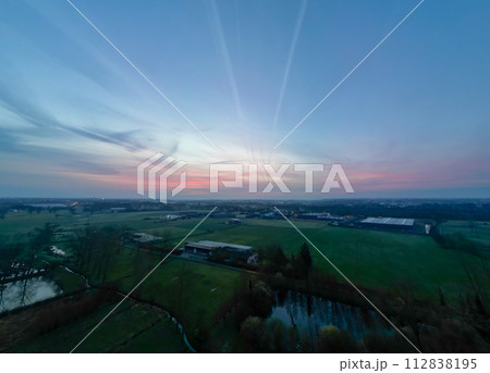 Sunset Over Industrial Harmony: A Tranquil End to a Day in Agriculture Sunset Over Industrial Harmony: A Tranquil End to a Day in Agriculture 112838195