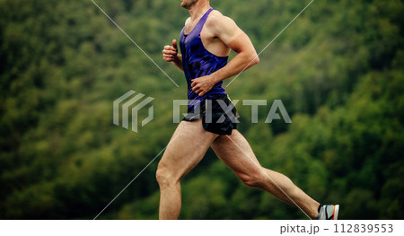 close-up man athlete running in background of green forest 112839553