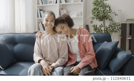 Happy sisters hugging, smiling on camera, family togetherness, relationship Happy sisters hugging, smiling on camera, family togetherness, relationship 112840631