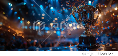 AI-generated content. Golden trophy standing against blue neon background with lights and confetti. Banner. Winning game AI-generated content. Golden trophy standing against blue neon background with lights and confetti. Banner. Winning game 112841271