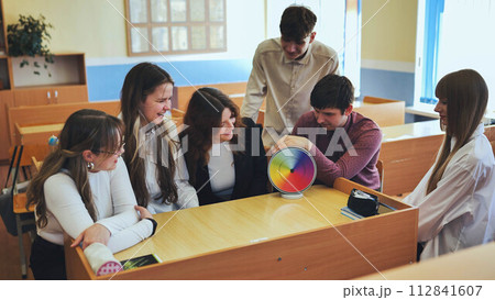 Students in physics class spin Newton's multicolored disk. Students in physics class spin Newton's multicolored disk. 112841607