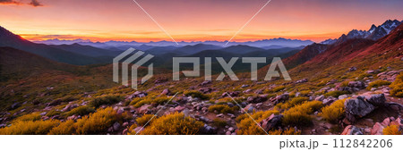 Rugged beauty of a mountain range at golden hour, with the sun setting in the background 112842206