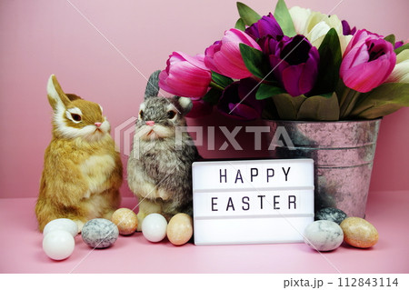 Happy Easter light box with easter element decoration on pink background Happy Easter light box with easter element decoration on pink background 112843114