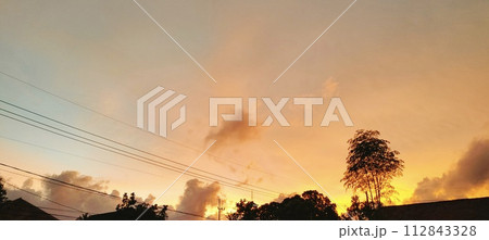 Beautiful twilight and clouds with golden yellow sunlight Beautiful twilight and clouds with golden yellow sunlight 112843328