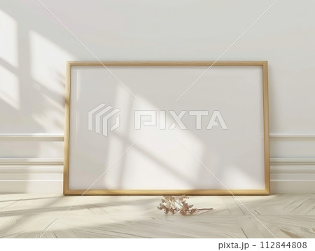 Blank picture frame on the parquet floor in room 112844808