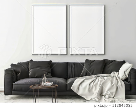 Two white poster mockups hang above a dark sofa, advertisement inspired, 112845053