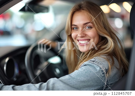 Beautiful, caucasian, young happy woman with warm smile driving her car. Close up portrait of female with glad positive expression enjoying travel 112845707